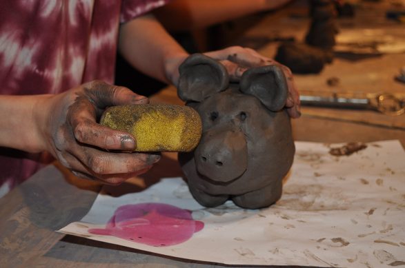 Learning to sculpt in clay at Wychwood.